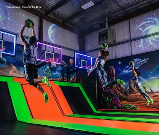 Guests gathered inside Planet Jump under cosmic lighting and atmospheric glow.